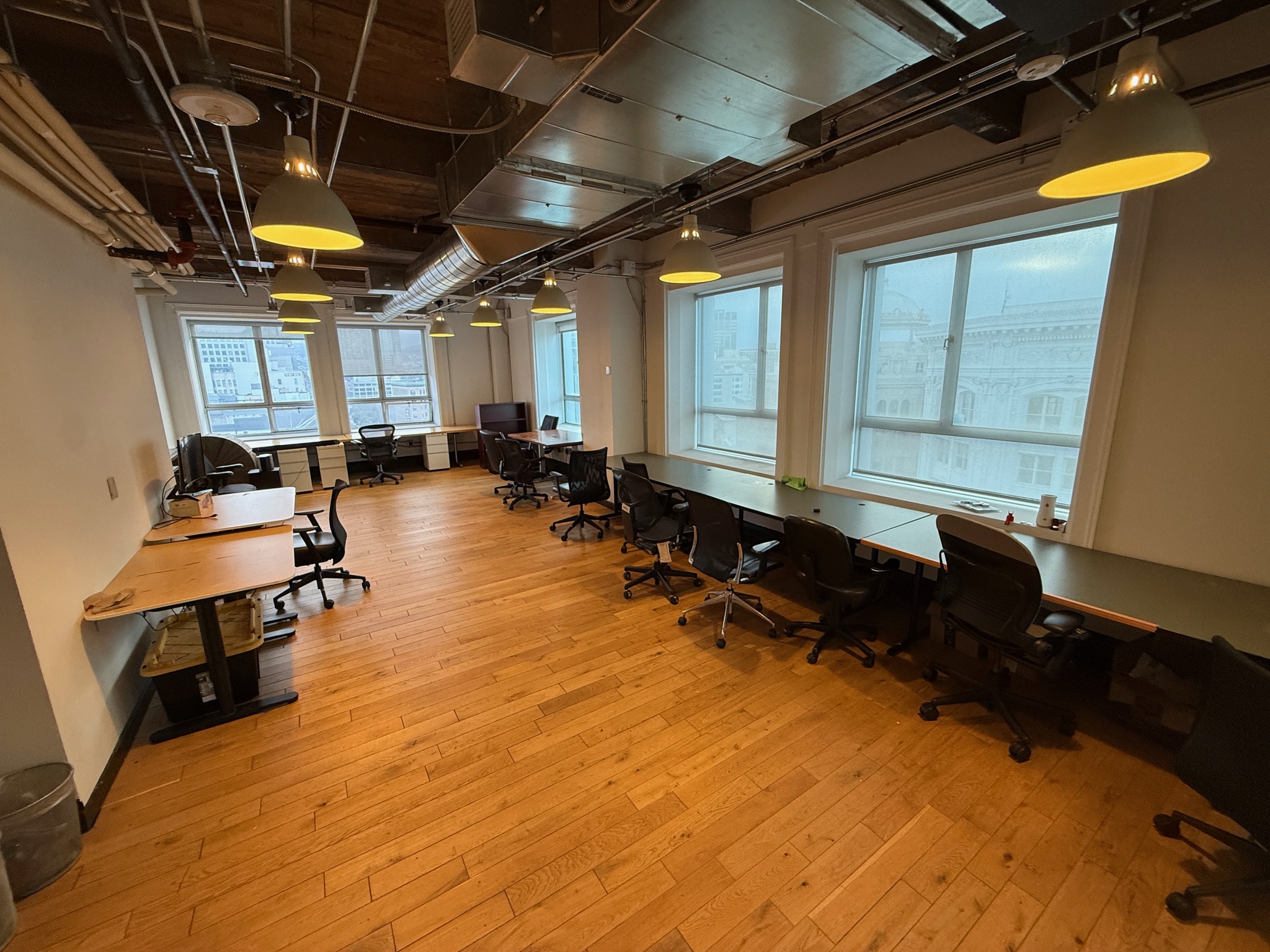 Dedicated desk area with standing desks and ergonomic chairs