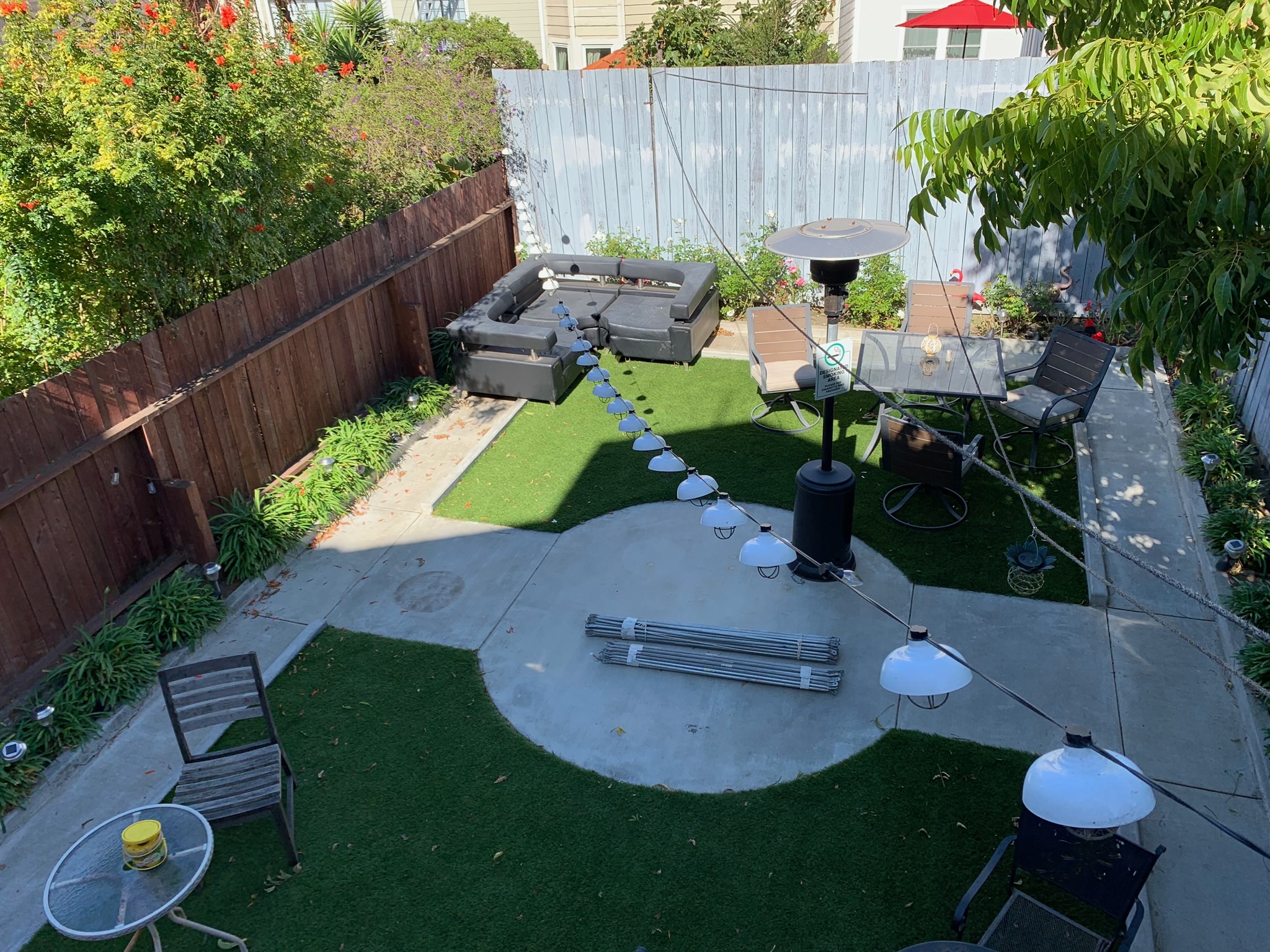 Backyard with artificial grass, string lights, and outdoor seating