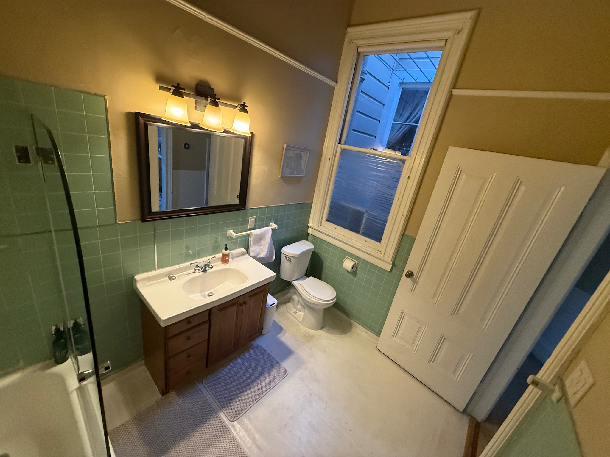 Bathroom with green tile and skylight