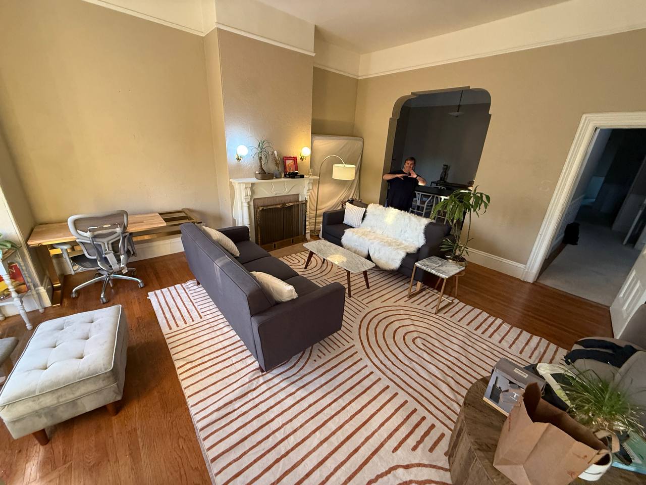 Living room with workspace, couches with fuzzy pillows